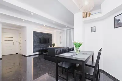 a living room with a black table and a couch at Comfy Apartment Lubelska Krakow by Noclegi Renters in Kraków