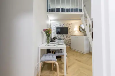 a small white room with a table and chairs at Cracow S31 in Kraków