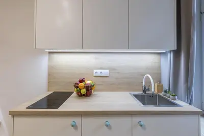 a kitchen counter with a bowl of fruit and a sink at Cracow S31 in Kraków