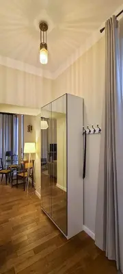 a glass refrigerator in a room with a table at Stylish apartment in trendiest area in Kraków