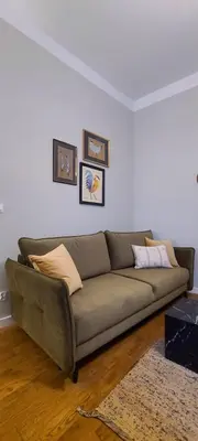 a living room with a couch in a room at Stylish apartment in trendiest area in Kraków