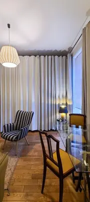 a living room with a glass table and chairs at Stylish apartment in trendiest area in Kraków