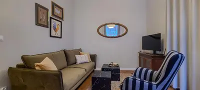 a living room with a couch and a chair at Stylish apartment in trendiest area in Kraków