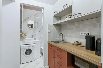 a kitchen with a sink and a washing machine at Apartament Targowy by LookAp in Kraków