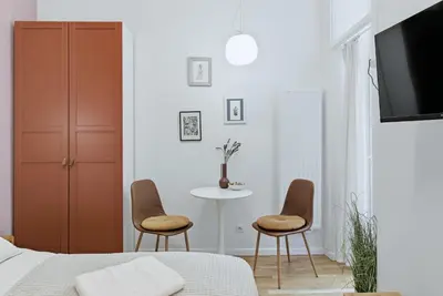 a bedroom with two chairs and a table at Apartament Targowy by LookAp in Kraków