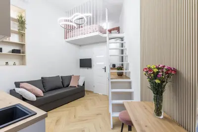 a living room with a couch and a table at Cracow Old Town S31 in Kraków