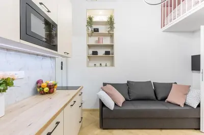 a living room with a couch and a tv at Cracow Old Town S31 in Kraków