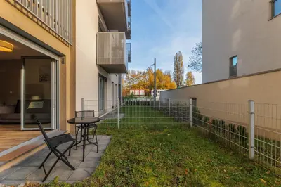a patio with a table and chairs next to a building at Prandoty 10B by Homeprime in Kraków