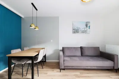 a dining room with a couch and a table at Prandoty 10B by Homeprime in Kraków