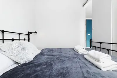 a bedroom with a bed with two towels on it at Prandoty 10B by Homeprime in Kraków