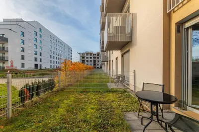 a table and chairs on a balcony in a building at Prandoty 10B by Homeprime in Kraków