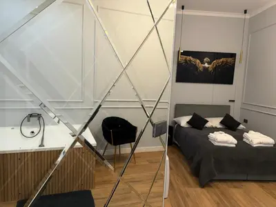 a bedroom with a bed and a glass wall at Apartament Grey Prywatne Jacuzzi Miodowa Kraków in Kraków