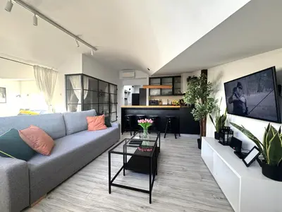 a living room with a couch and a table at Grodzka Loft in Kraków