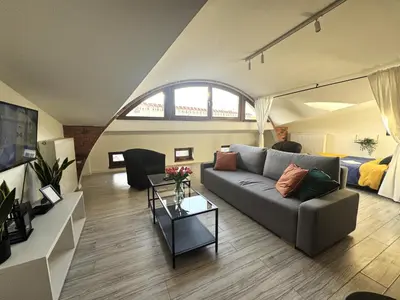 a living room with a couch and a bed at Grodzka Loft in Kraków