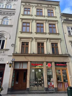 a tall building with many windows on a street at Grodzka Loft in Kraków