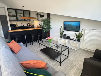 a living room with a couch and a bar at Grodzka Loft in Kraków