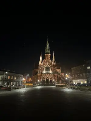 a large building with a clock tower at night at Solna Studio Apartment - Comfort Stay in Heart of Kraków in Kraków