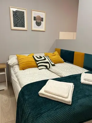 a room with two beds with towels on them at Solna Studio Apartment - Comfort Stay in Heart of Kraków in Kraków