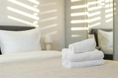 a pile of towels sitting on top of a bed at Ciesielskiego Cozy Studio by BookingHost in Kraków