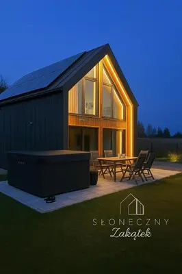 a large house with a patio and a table at Słoneczny Zakątek 2025