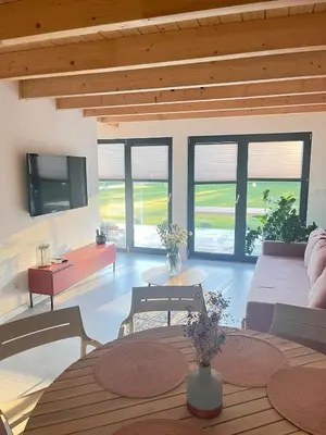 a living room with a couch and a table at Słoneczny Zakątek 2025