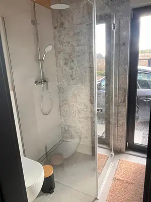 a bathroom with a shower and a toilet at Słoneczny Zakątek 2025
