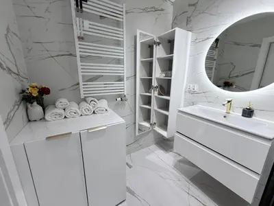 a white bathroom with a sink and a mirror at Apartament Dobrego Pasterza 46 Free Parking in Kraków