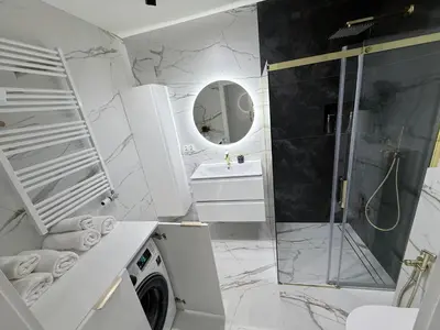 a white bathroom with a shower and a sink at Apartament Dobrego Pasterza 46 Free Parking in Kraków