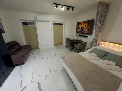 a room with a bed and a couch and a table at Apartament Dobrego Pasterza 46 Free Parking in Kraków