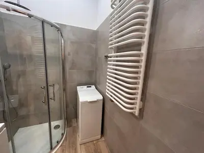 a bathroom with a glass shower and a toilet at Old Town Apartments B15 in Kraków