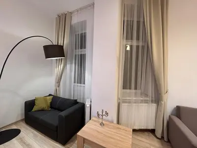 a living room with a couch and a table at Old Town Apartments B15 in Kraków
