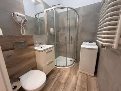a bathroom with a shower and a toilet and a sink at Old Town Apartments B15 in Kraków