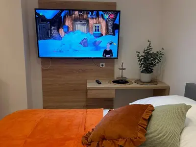 a living room with a flat screen tv on a wall at Old Town Apartments B15 in Kraków