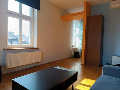 a living room with a couch and a table at Appartement au coeur de Kazimierz in Kraków