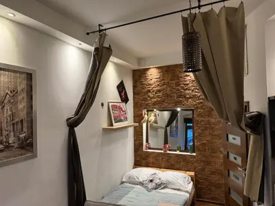 a bed in a room with a brick wall at Relax in Kraków