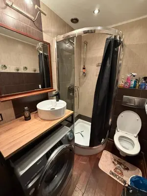 a bathroom with a washing machine and a shower at Relax in Kraków