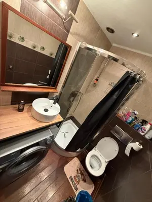 a small bathroom with a toilet and a sink at Relax in Kraków