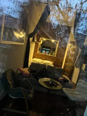 a room with a table and a bed and a mirror at Relax in Kraków