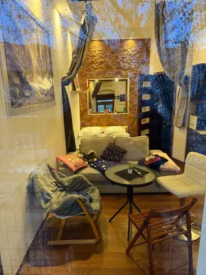 a room with a bed and a table and a mirror at Relax in Kraków
