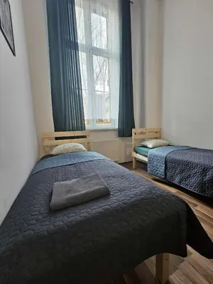 a bedroom with two beds and a window at Cozy Apartment in Krakow in Kraków