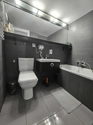 a bathroom with a toilet and a sink and a bath tub at Cozy Apartment in Krakow in Kraków