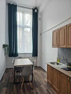 a kitchen with a table and a sink and a window at Cozy Apartment in Krakow in Kraków