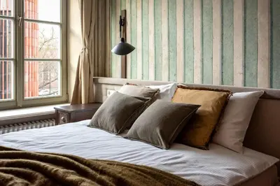 a bed with pillows on it in a bedroom at Nobilis Apartments by MB Apartments in Kraków