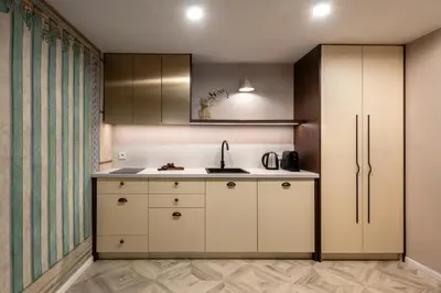 a kitchen with white cabinets and a sink at Nobilis Apartments by MB Apartments in Kraków