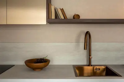 a kitchen counter with a sink and a bowl of fruit at Nobilis Apartments by MB Apartments in Kraków