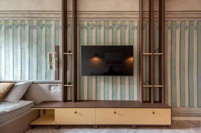 a living room with a tv on a wall at Nobilis Apartments by MB Apartments in Kraków