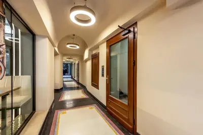 a hallway with a door and a hallway with rugs at Nobilis Apartments by MB Apartments in Kraków
