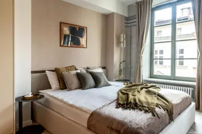 a bedroom with a large bed in front of a window at Nobilis Apartments by MB Apartments in Kraków