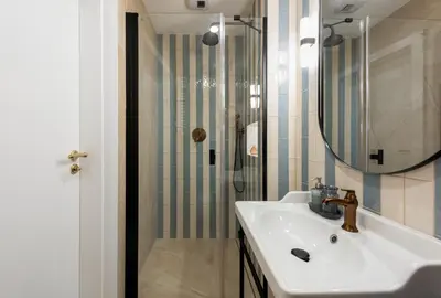 a bathroom with a sink and a shower at Nobilis Apartments by MB Apartments in Kraków