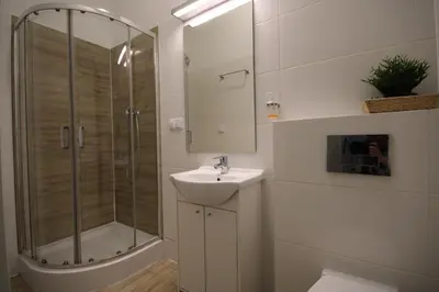 a bathroom with a sink and a shower at Krakow Central Vintage Apartment by Rently in Kraków